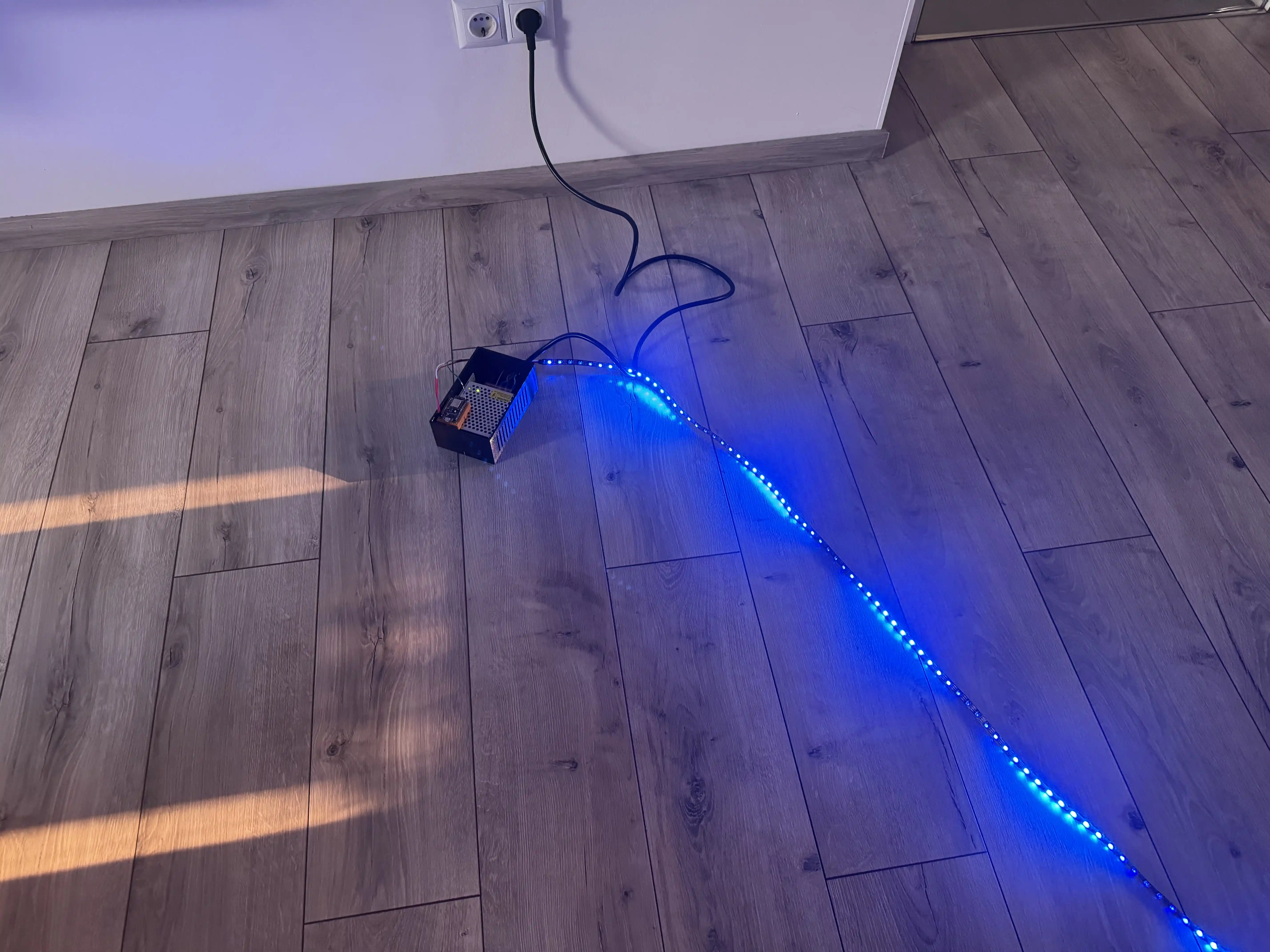 A breadboard with a GPIO extended board three RGB LEDs and one electric motor with a fan on top.